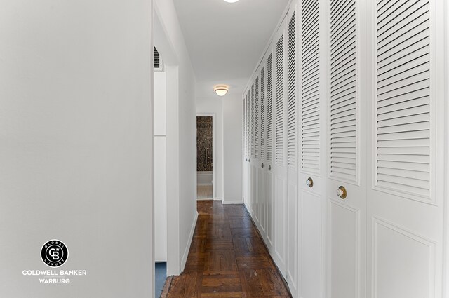 corridor featuring baseboards and visible vents