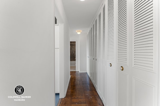 hall featuring visible vents and baseboards