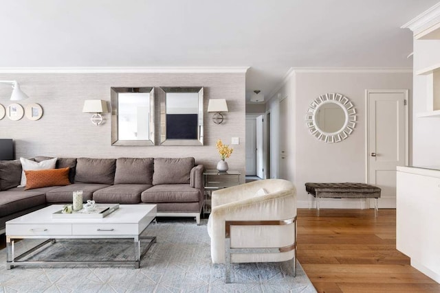 living area with baseboards, wood finished floors, and crown molding