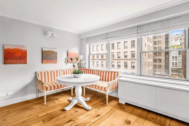 10 W 15th St Unit 1027/1028, New York City, NY 10011 - dining space with breakfast area, ornamental molding, plenty of natural light, light wood-type flooring, and baseboards