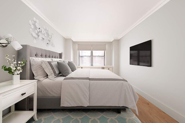 bedroom with baseboards, ornamental molding, and wood finished floors