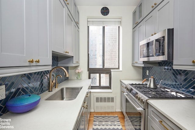 kitchen with a sink, visible vents, light countertops, appliances with stainless steel finishes, and tasteful backsplash