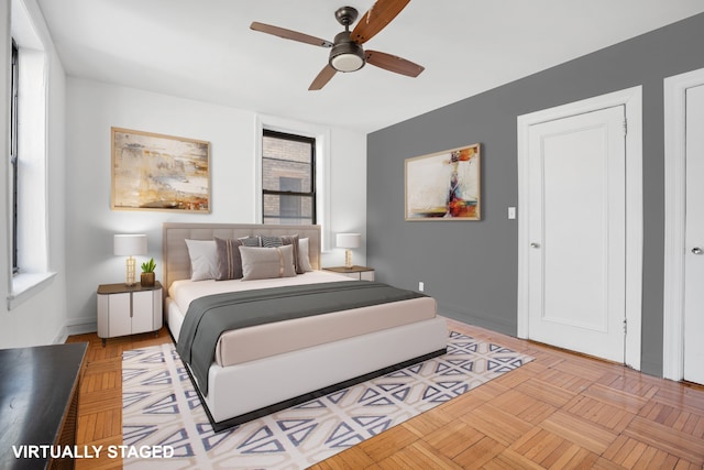 bedroom with a ceiling fan and baseboards