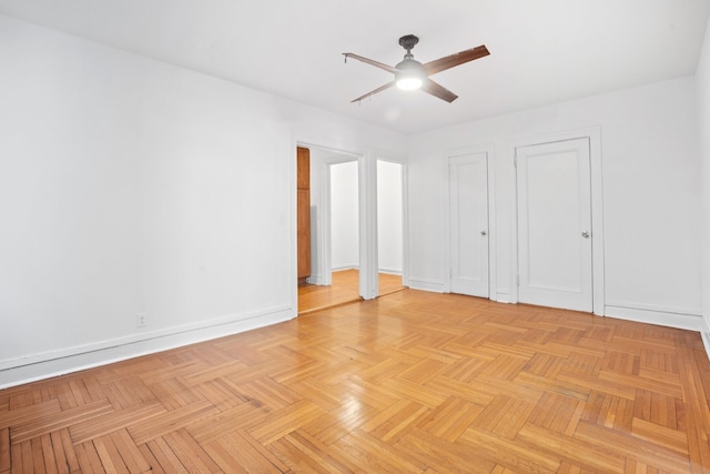 unfurnished room featuring a ceiling fan and baseboards
