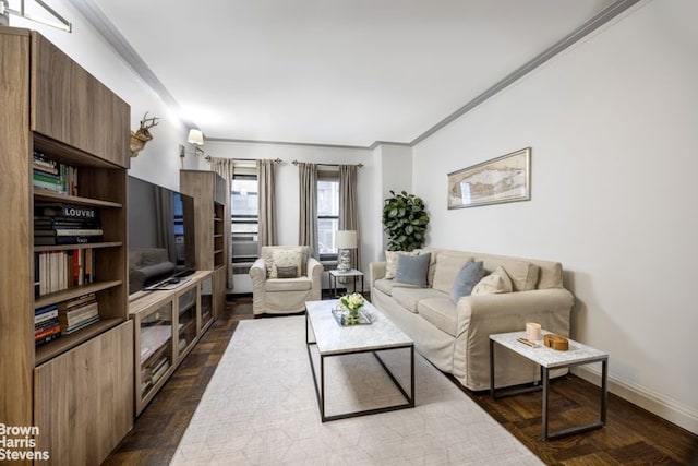 living area featuring dark wood-type flooring, baseboards, and ornamental molding