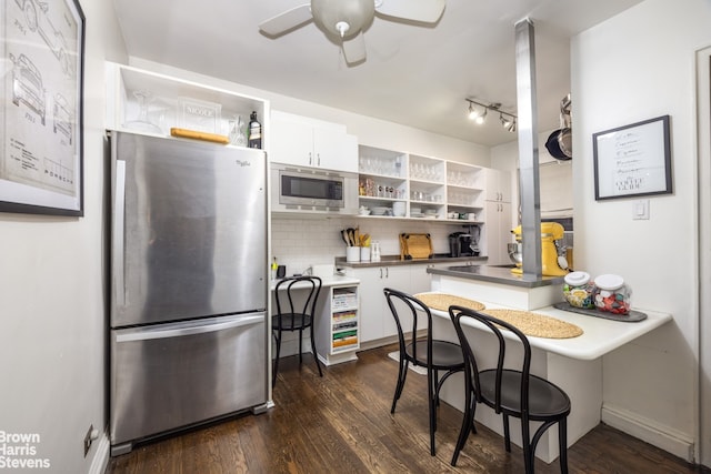 kitchen featuring dark wood finished floors, white cabinets, appliances with stainless steel finishes, and open shelves