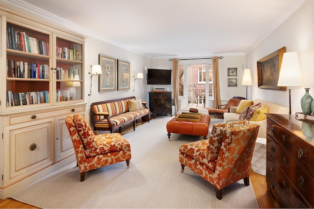 living room featuring wood finished floors and crown molding