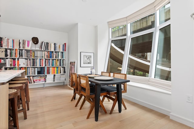 dining space with a healthy amount of sunlight and light wood-style floors