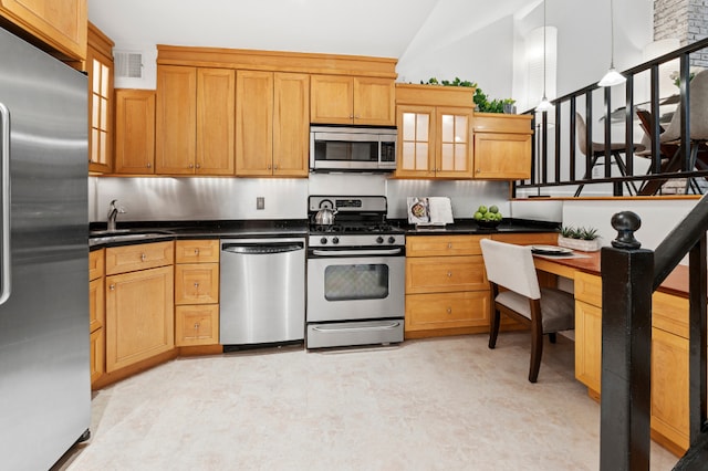 kitchen featuring visible vents, dark countertops, a sink, glass insert cabinets, and stainless steel appliances