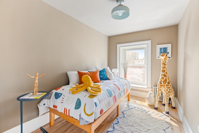 bedroom featuring baseboards and wood finished floors