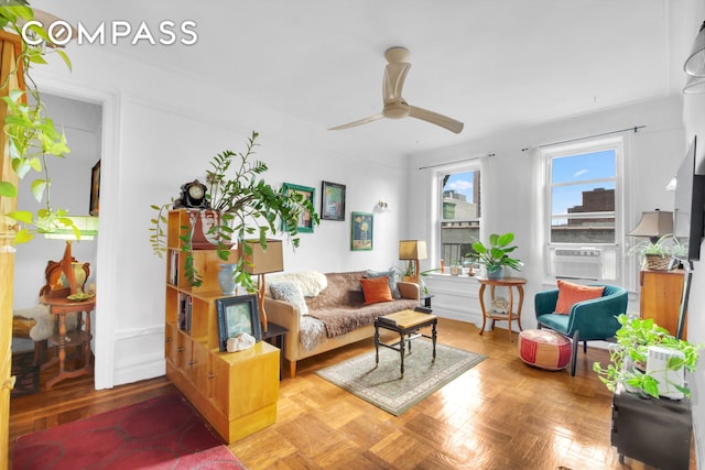 living area with a ceiling fan and cooling unit