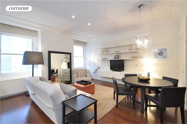 living area with dark wood-type flooring, recessed lighting, visible vents, and a notable chandelier