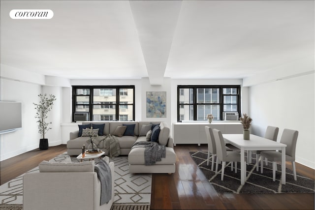 living room with cooling unit, dark wood-style flooring, visible vents, and baseboards