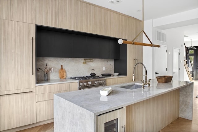 kitchen with high end stainless steel range oven, modern cabinets, and visible vents