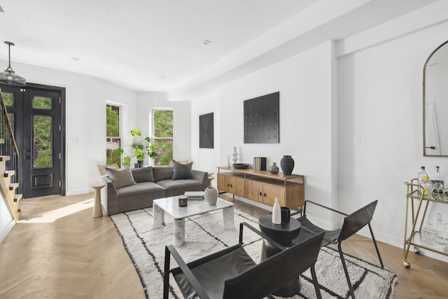 living room featuring stairway and baseboards