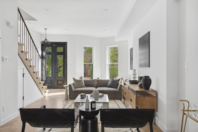 living room with stairway and baseboards