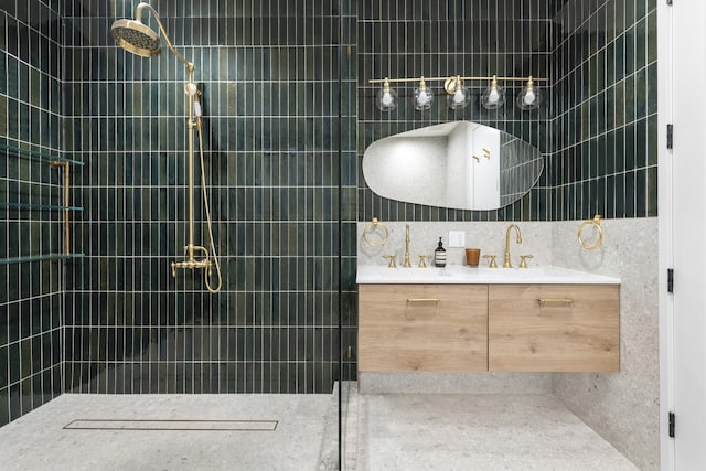 full bathroom with tile walls, decorative backsplash, tiled shower, and vanity