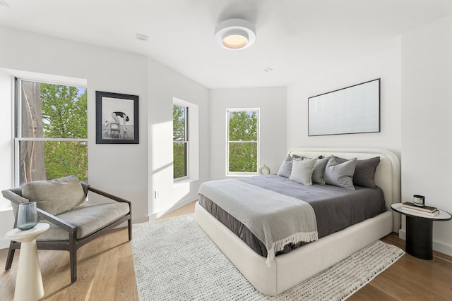 bedroom featuring wood finished floors and baseboards