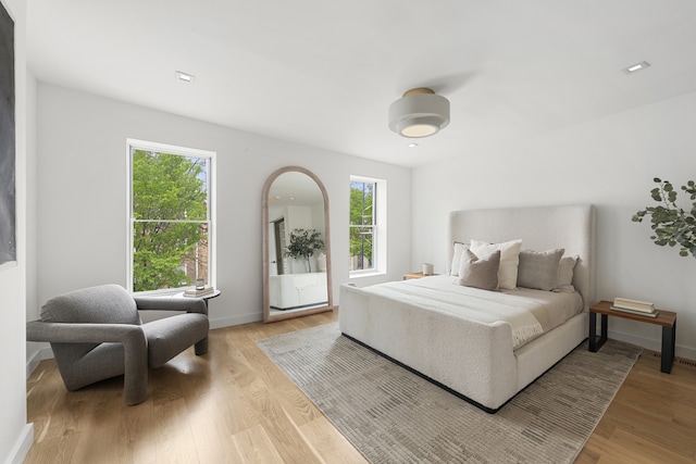 bedroom featuring wood finished floors and baseboards