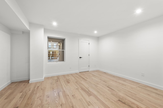 empty room with recessed lighting, baseboards, and light wood-style floors