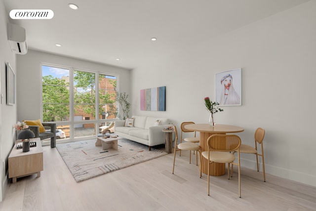 living area featuring visible vents, a wall mounted AC, wood finished floors, recessed lighting, and baseboards