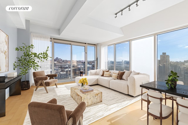 sunroom / solarium with rail lighting, visible vents, and a city view