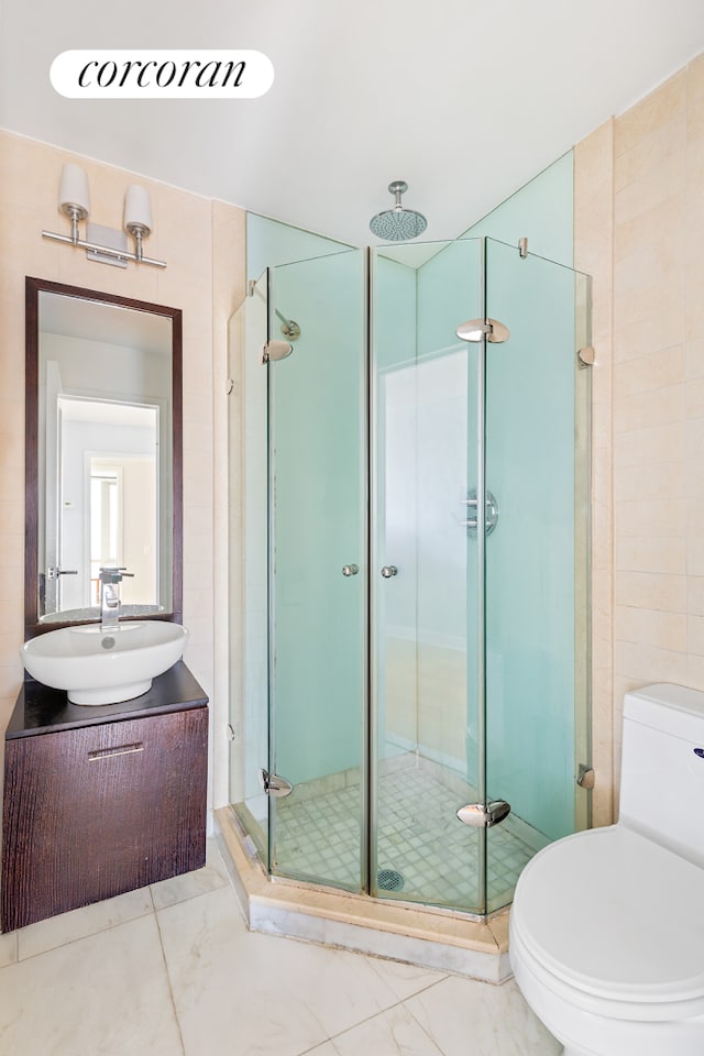 full bath with toilet, marble finish floor, a shower stall, and vanity