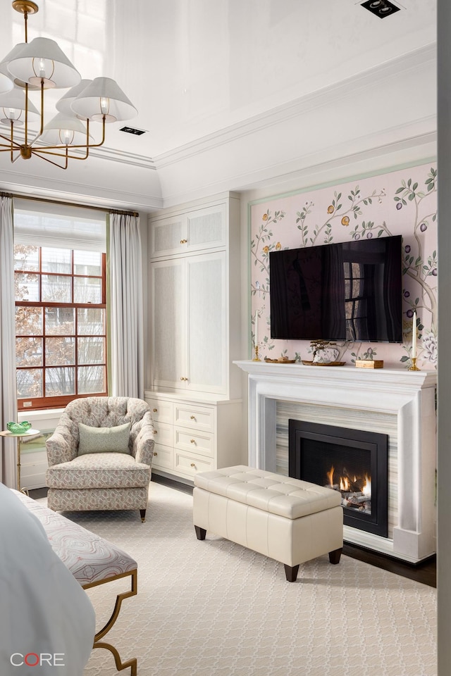 living area with a chandelier, carpet floors, visible vents, and a lit fireplace