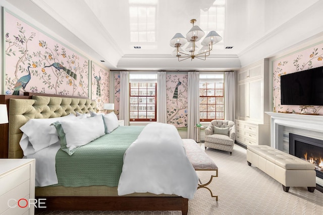 carpeted bedroom with a chandelier, crown molding, a lit fireplace, and wallpapered walls