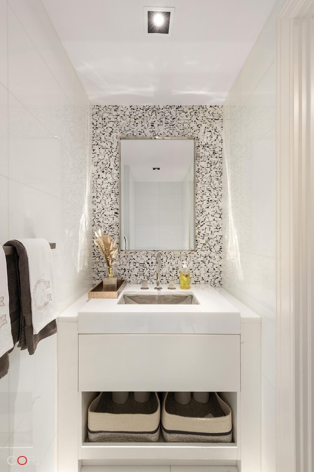 bathroom featuring a sink and backsplash