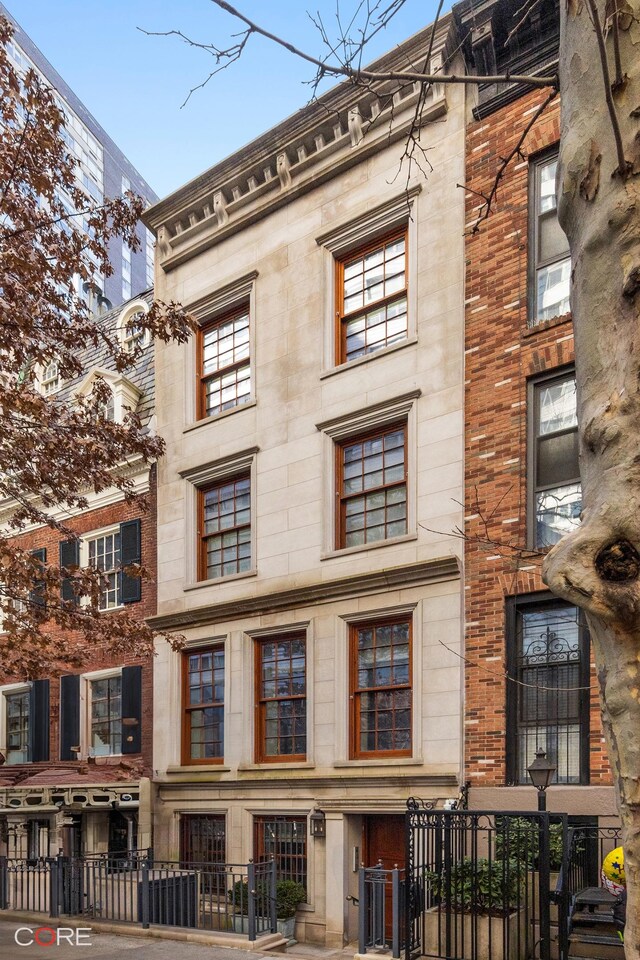 238 E 68th St, New York City, NY 10065 - view of building exterior with a fenced front yard