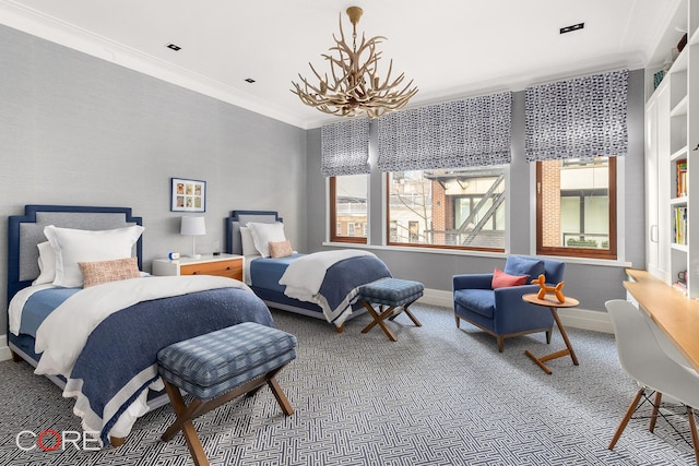 carpeted bedroom with crown molding, baseboards, and an inviting chandelier