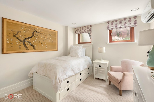 bedroom with baseboards and a wall mounted air conditioner