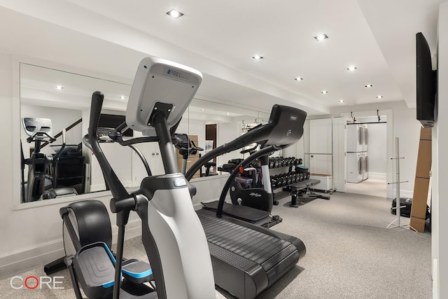 exercise room with light carpet, baseboards, washer / clothes dryer, and recessed lighting