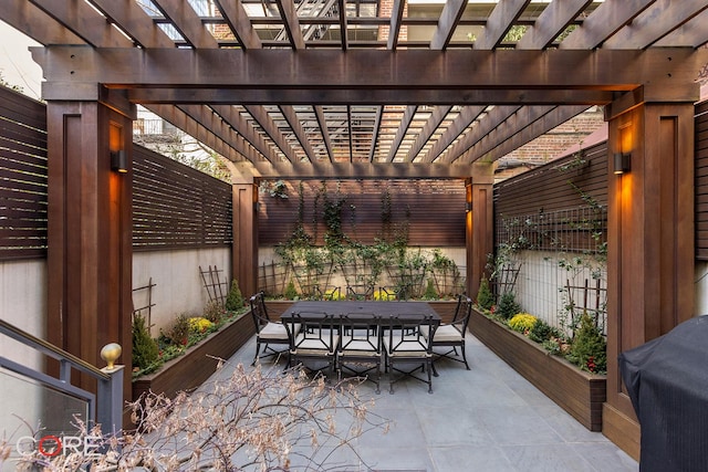 view of patio featuring outdoor dining area, fence, and a pergola