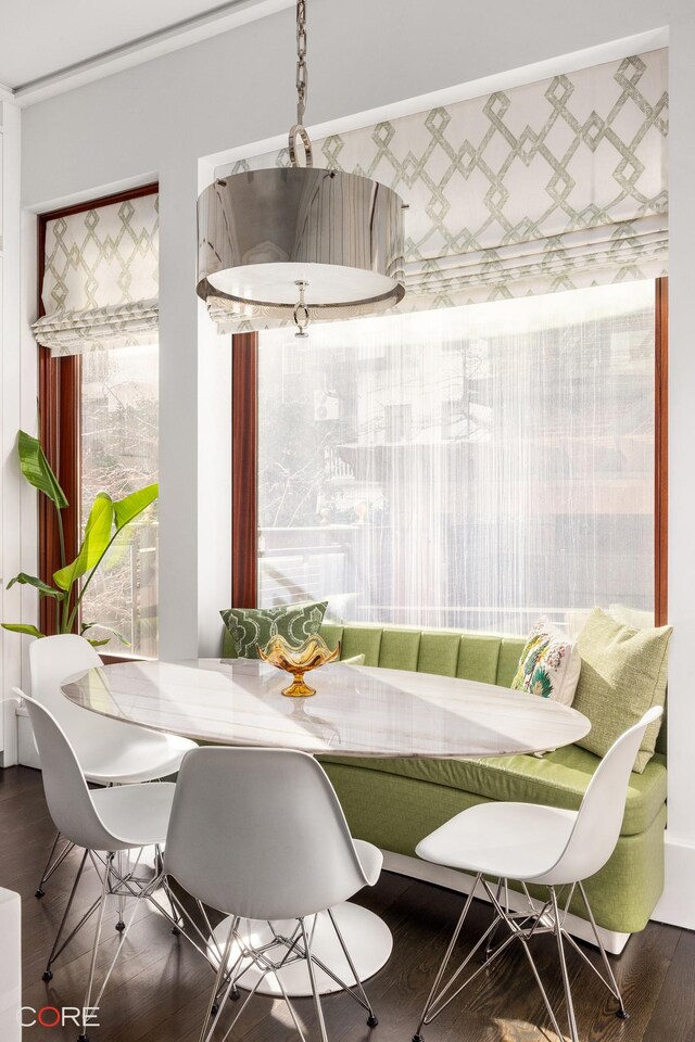 238 E 68th St, New York City, NY 10065 - dining area with wallpapered walls, a raised ceiling, wood finished floors, crown molding, and a notable chandelier