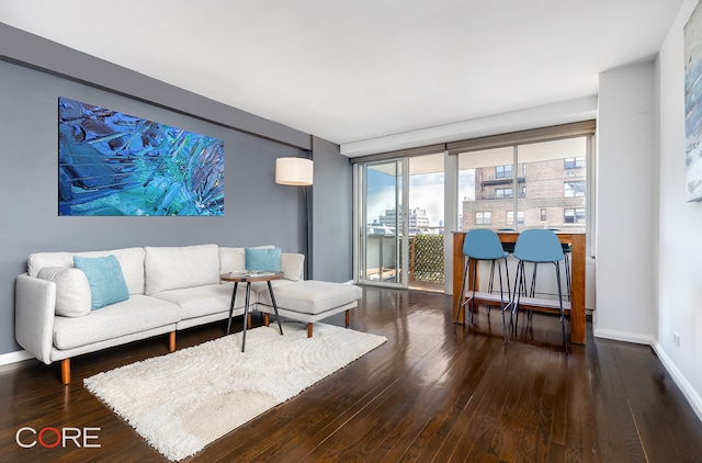 living area with hardwood / wood-style flooring and baseboards