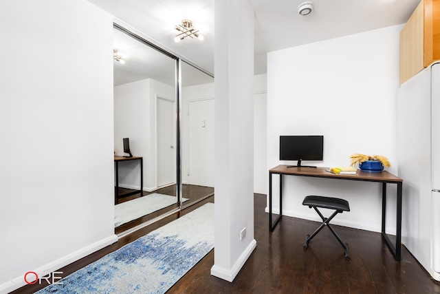 office space with baseboards and wood finished floors