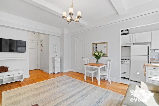 interior space featuring light wood-style floors, beam ceiling, a chandelier, and baseboards