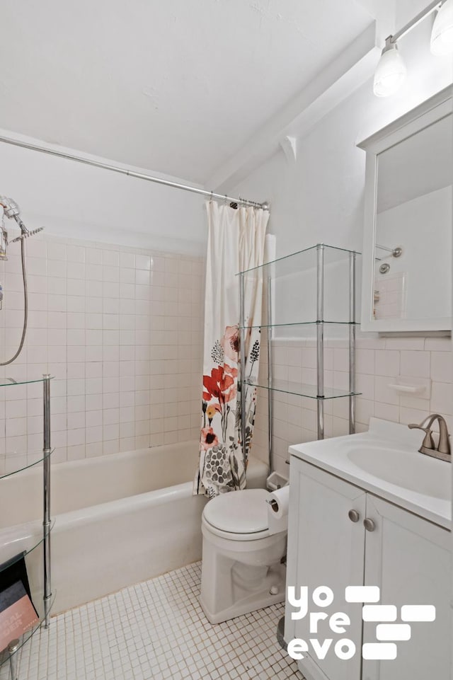 full bathroom with shower / tub combo, toilet, tile patterned flooring, vanity, and tile walls