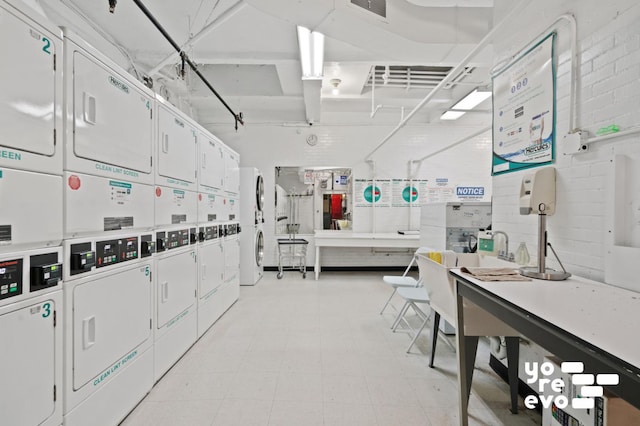 misc room with visible vents, separate washer and dryer, and stacked washer / drying machine