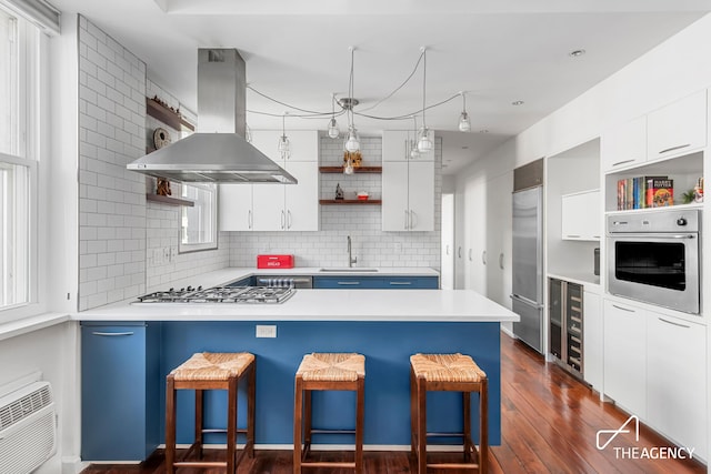 340 W 55th St Unit 6D, New York City, NY 10019 - kitchen with open shelves, island range hood, stainless steel appliances, beverage cooler, and a sink
