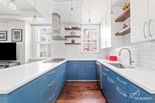 kitchen with open shelves, exhaust hood, and blue cabinets