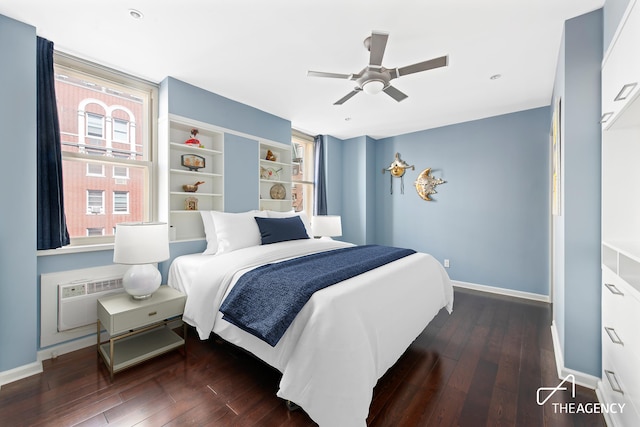 bedroom featuring baseboards, a ceiling fan, a wall unit AC, and wood finished floors