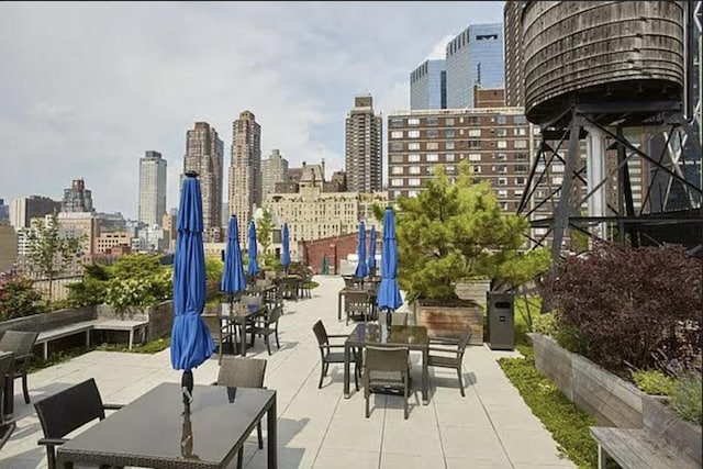 340 W 55th St Unit 6D, New York City, NY 10019 - view of patio / terrace featuring a view of skyline and outdoor dining area