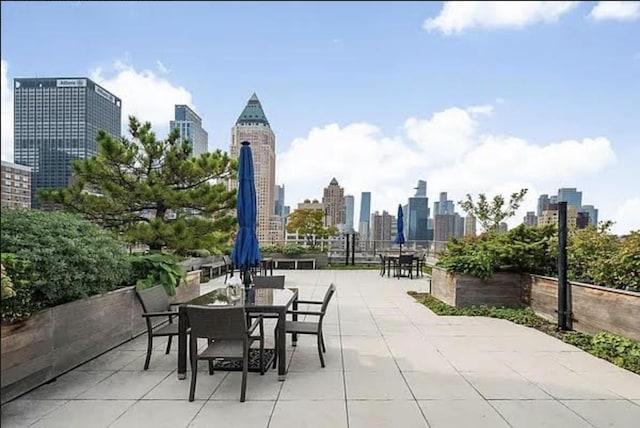 340 W 55th St Unit 6D, New York City, NY 10019 - view of patio / terrace featuring a skyline view and outdoor dining area