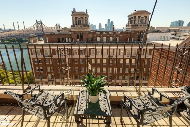 balcony with a view of city and a water view