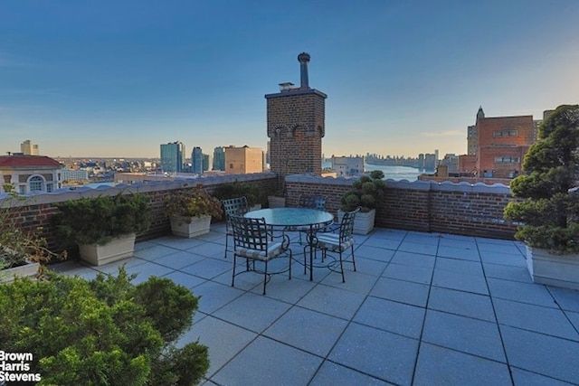 view of patio featuring a view of city and outdoor dining area