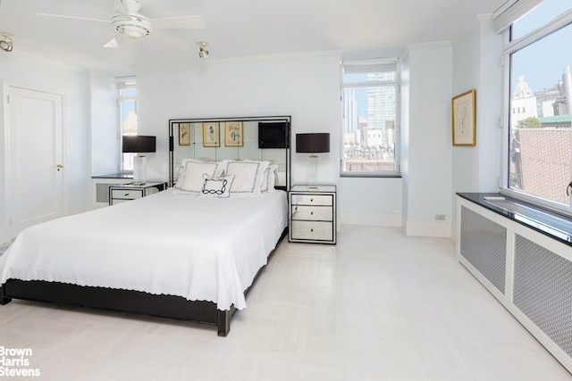 bedroom with radiator heating unit, multiple windows, ornamental molding, and baseboards