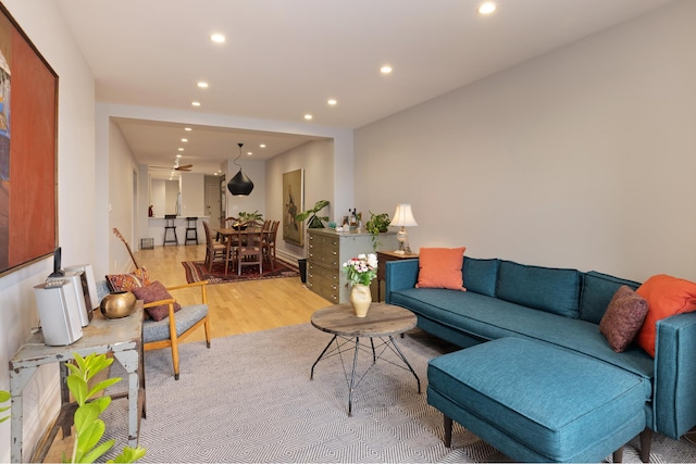 living area with light wood-type flooring and recessed lighting